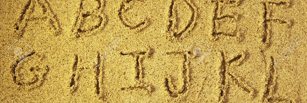 7658659-alphabet-letters-handwritten-in-sand-on-beach--Stock-Photo
